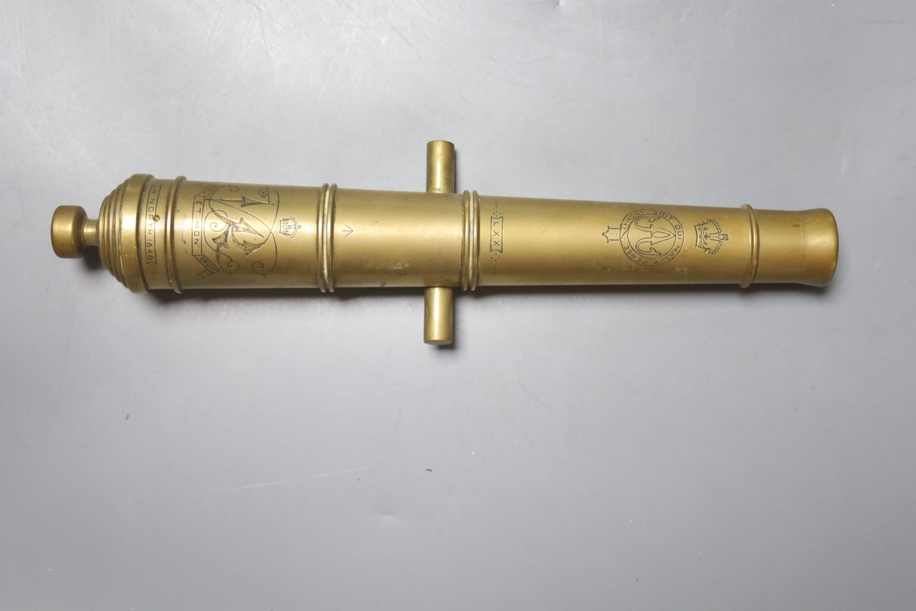 A bronze model cannon engraved  W. North 1848, 25.5cm, a bronze cannon on an associated carriage, 26.5cm, various small brass cannon